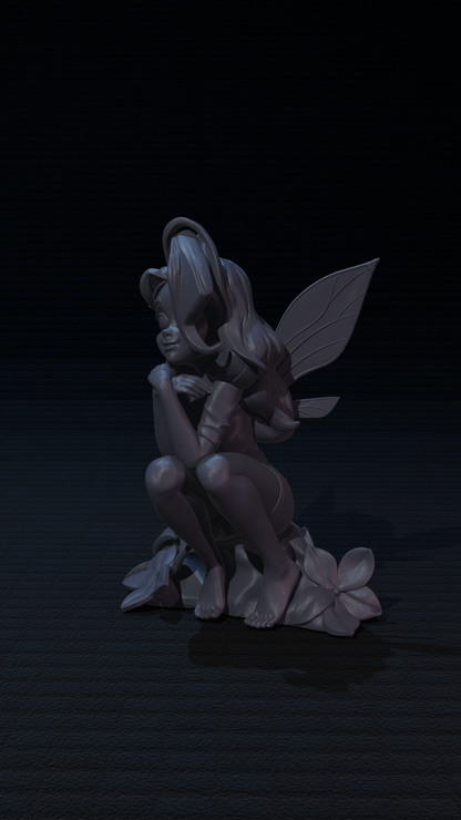 a statue of a fairy sitting on a flower