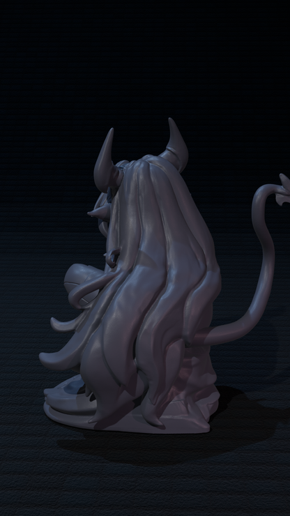 a statue of a demon sitting on a black surface