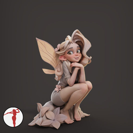 a figurine of a fairy sitting on a rock