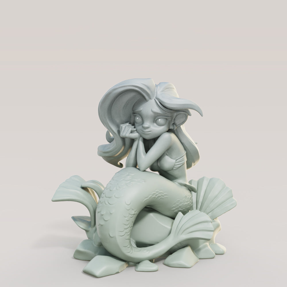 a statue of a mermaid sitting on top of a fish